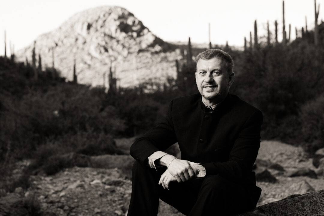 Musical Director Linus Lerner sits for a portrait in the Sonoran desert.