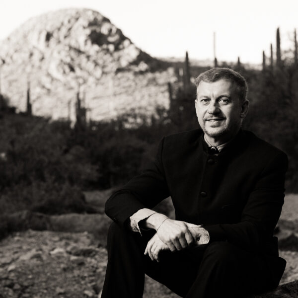 Musical Director Linus Lerner sits for a portrait in the Sonoran desert.